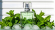 © Sorosoti - Glass perfume bottle with mint leaves and water droplets on white background
