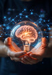 © Kamrunnahar - Hands holding glowing brain lightbulb inside glass sphere with network connections