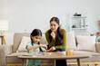 © David - Mother and daughter learning playing puzzle at home