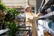 © Ivan Traimak - Senior woman shopping for new flowerpots in a retail garden center
