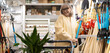 © Ivan Traimak - Smiling senior woman choosing a shovel in a hardware store aisle