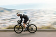 © peopleimages.com - Fitness, bike or cyclist outdoor with motion blur, endurance training or speed in cardio workout. Fast, space or male person on road with bicycle, physical activity or riding practice in sport hobby.