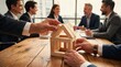 © tarik - Business team hands building house model from wooden blocks on meeting table representing teamwork real estate planning mortgage insurance and investment strategy concept