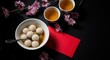 © kagraphixion - Sweet rice balls in ginger soup for lunar new year celebration with red envelope