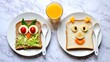 © olga_demina - A creative and playful breakfast setup for kids featuring food art on toast and a glass of orange juice on a marble table, promoting a fun and healthy meal experience.