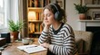 © FN Visuals - young woman listening to podcast or music on headphones at home