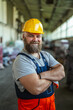 © Miljan Živković - Industrial worker wearing hard hat standing in a factory