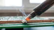 © imagemir - Close-up of A Soldering Iron Melting Solder Onto Copper Wires Creating A Strong Electrical Connection Concept Architecture and Design