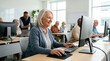 © Xenia - Smiling elderly woman using a computer in a classroom. Senior lady learning digital skills in an adult education center
