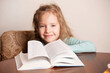 © Tatyana Gladskih - Portrait of Girl reading book at home. Child education