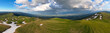 © AmazingAerialAgency - Aerial view of Le Colomby de Gex mountain ridge with patches of melting snow overlooking the Geneva basin under a dramatic cloudy sky Echenevex, Auvergne-Rhone-Alpes, France.