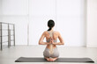 © New Africa - Woman practicing yoga indoors. Illustration of spinal column on her back