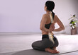 © New Africa - Woman practicing yoga indoors. Illustration of spinal column on her back