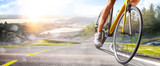 Cycling. A captivating shot of a helmeted biker riding along an asphalt road. Cycling competitions. Active recreation. Sport. Professional road bicycle racer close up view