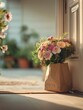 © Santi - Fresh bouquet gift bag florist delivery on doorstep with pastel flower arrangement in warm home entrance light