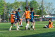 © chokniti - World cup concept with soccer ball or football player, youth soccer players practice on outdoor field with goal and net in sunny park, teamwork, active play