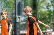 © chokniti - World cup concept with soccer ball or football player, boy in orange vest plays outdoors on field