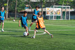 © chokniti - World cup concept with soccer ball or football player, youth soccer players compete on green field in outdoor game