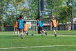 © chokniti - World cup concept with soccer ball or football player, youth soccer players on green field training near goal net in outdoor sports practice session