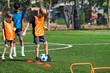 © chokniti - World cup concept with soccer ball or football player, youth soccer drill on green field with children practicing footwork and ball control