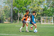 © chokniti - World cup concept with soccer or football player, youth soccer practice on green field with two children running after ball