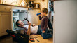 © Ivul - Celebrating Father's Day with quality time, a caring dad shows his eager son how to fix household plumbing, building cherished memories and practical knowledge