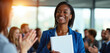 © miss irine - Black woman in blue suit smiles holding document. Colleagues clap, celebrating her achievement and success. Teamwork recognition in modern office.
