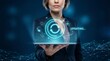 © space_creator - Businesswoman holds a tablet displaying a glowing blue holographic interface showing system updates and digital technology concepts in a modern corporate setting.