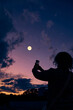 © astrosystem - Amateur astronomer with smartphone photographing and observing stars, planets, Moon and other celestial objects.