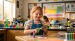 © My Creative Stock - A young girl using safety scissors to cut out paper shapes near a classroom science poster display.