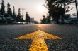 © Ihza - Sunlit arrow marking on asphalt road leading towards distant city skyline