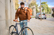 © Oscar - Delivery man pushing bicycle in urban street
