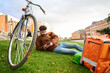 © Oscar - Courier relaxing on grass using smartphone