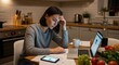 © Maryia - Busy woman burnout scene with exhausted adult woman working late at kitchen table, surrounded by laptop, papers, cold coffee and unfinished dinner tasks.