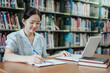 © Dara-Sroi - Asian Female Student Using Laptop in Library for Online Learning and Study