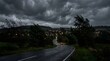 © Mst - A winding road through a rural town on a stormy evening with a car driving away