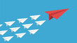 © nurul - A single red paper airplane leads a formation of white paper airplanes across a clear blue sky.