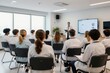 © Vadym - Doctor gives presentation to medical staff in modern room. Attendees watch screen, learn about healthcare innovation. Professionals collaborate, train, discuss medicine.