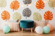 © Vadym - Childrens party decor with tropical leaves wall art. Teal ottoman, pillows, balloons create festive photo studio background. Bright tropical theme celebration setting.