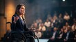 © Jittiwat - Woman in wheelchair giving a speech to an attentive audience in a conference.