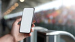 © A2Z AI  - Person hold a modern smartphone with a blank white screen, showcasing technology at an event with blurred crowd and bright sun flare in background