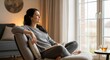 © Aldan - Thoughtful woman relaxing at home, looking out window with a book.
