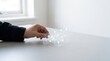 © KohXD - Person's hand touching a 3d model of a house symbolizing data-driven operations and business development strategy