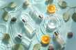 © KANATA - Luxury cosmetic bottles with glowing reflections on water surrounded by fresh green elegance
