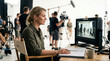 © Sali - Female director monitoring film production on set. Professional woman watching video playback on monitor during movie shoot
