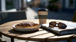 © ninakosh - Relaxing with coffee, a pastry, and a newspaper at a sunny outdoor cafe