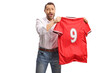 © Ljupco Smokovski - Man holding a red sports jersey with number nine