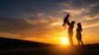© Ada - Happy Family Silhouette: Father Lifting Child with Mother at Sunset on Grassy Hill with Large Copy Space