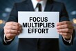 © Prazis Images - Man in Suit with a Sign: Focus Multiplies Effort