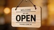 © Leo - Wooden hanging welcome sign with open text, business invitation for customers to come in, store front door display concept